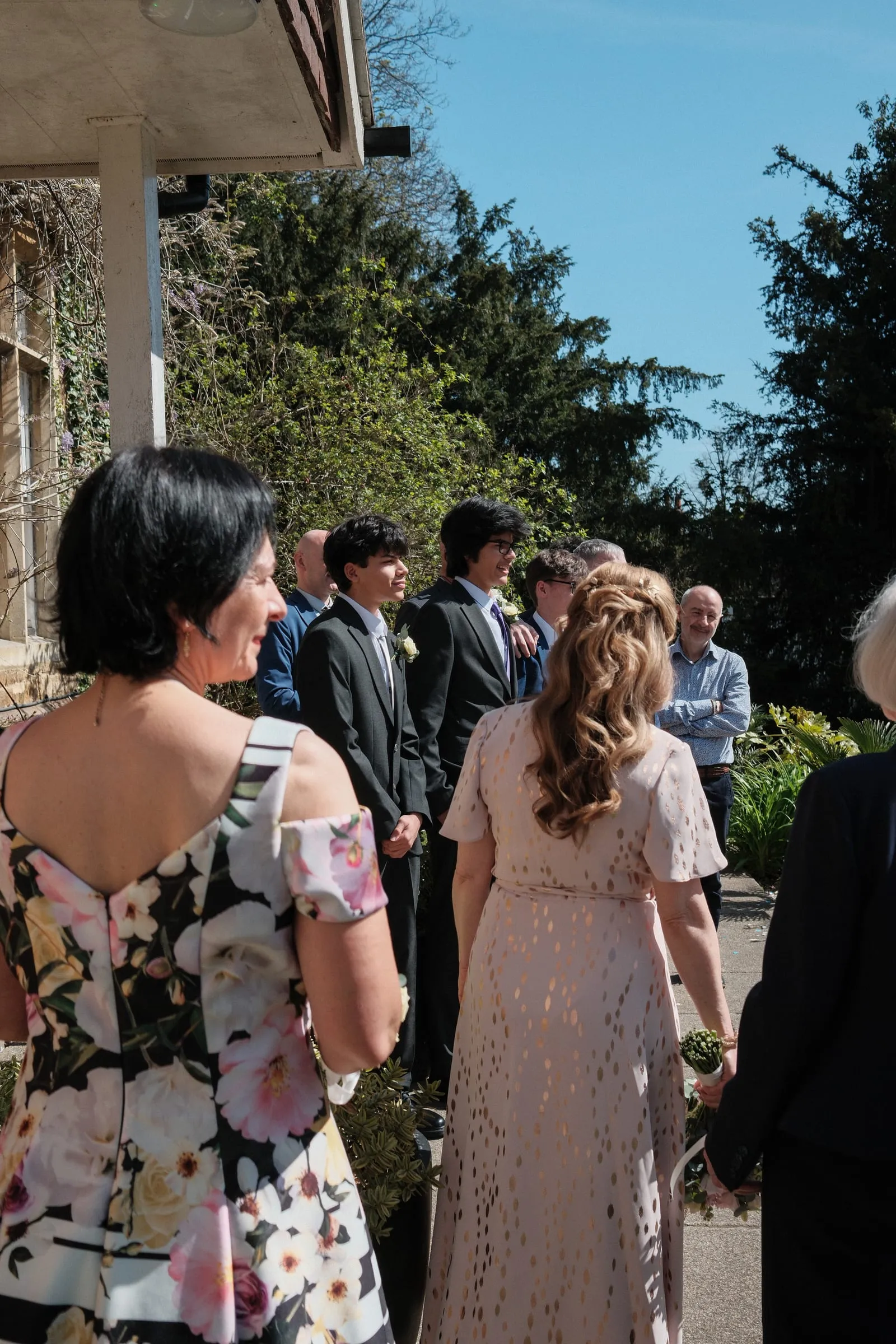 Guests gathered on the terrace in the sun.