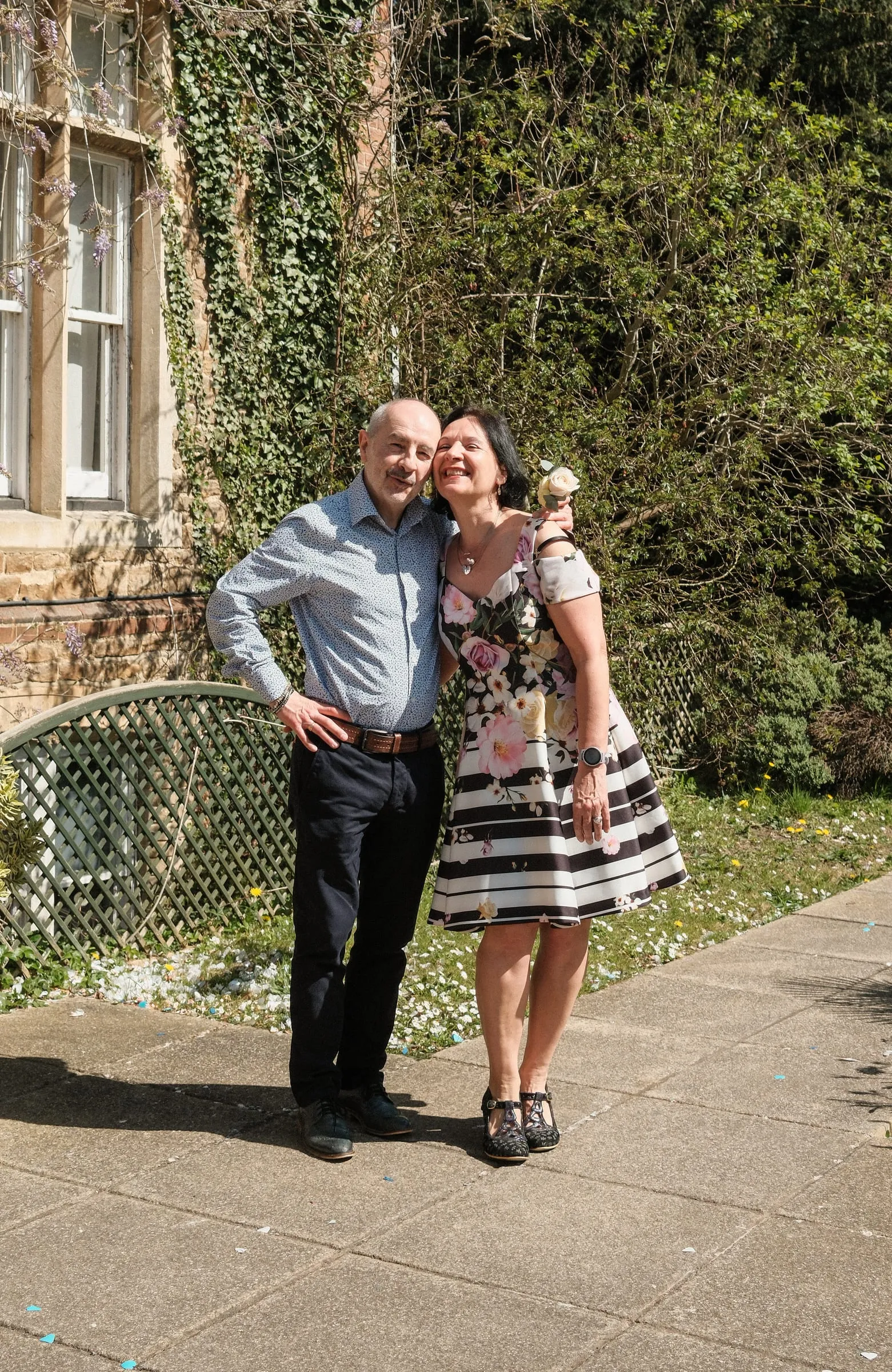 Two guests pose together in the sun.