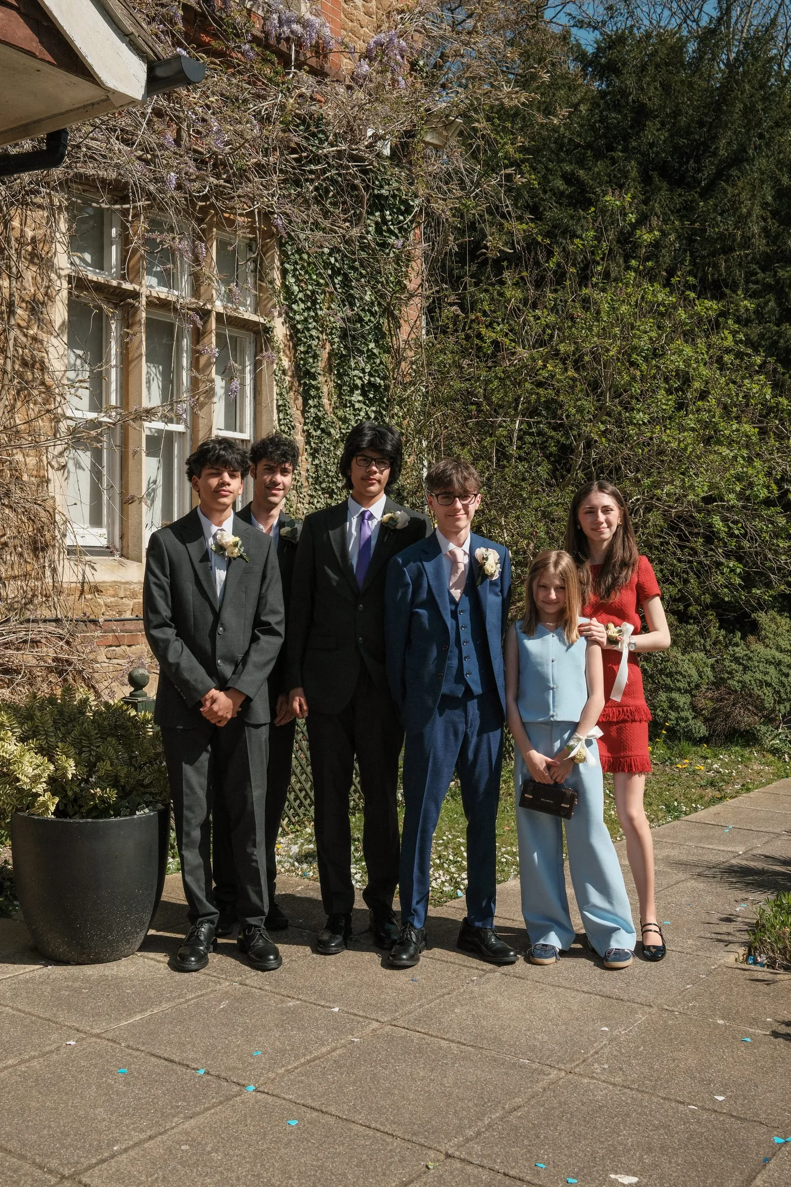 Four young men in suits with two girls beside them.