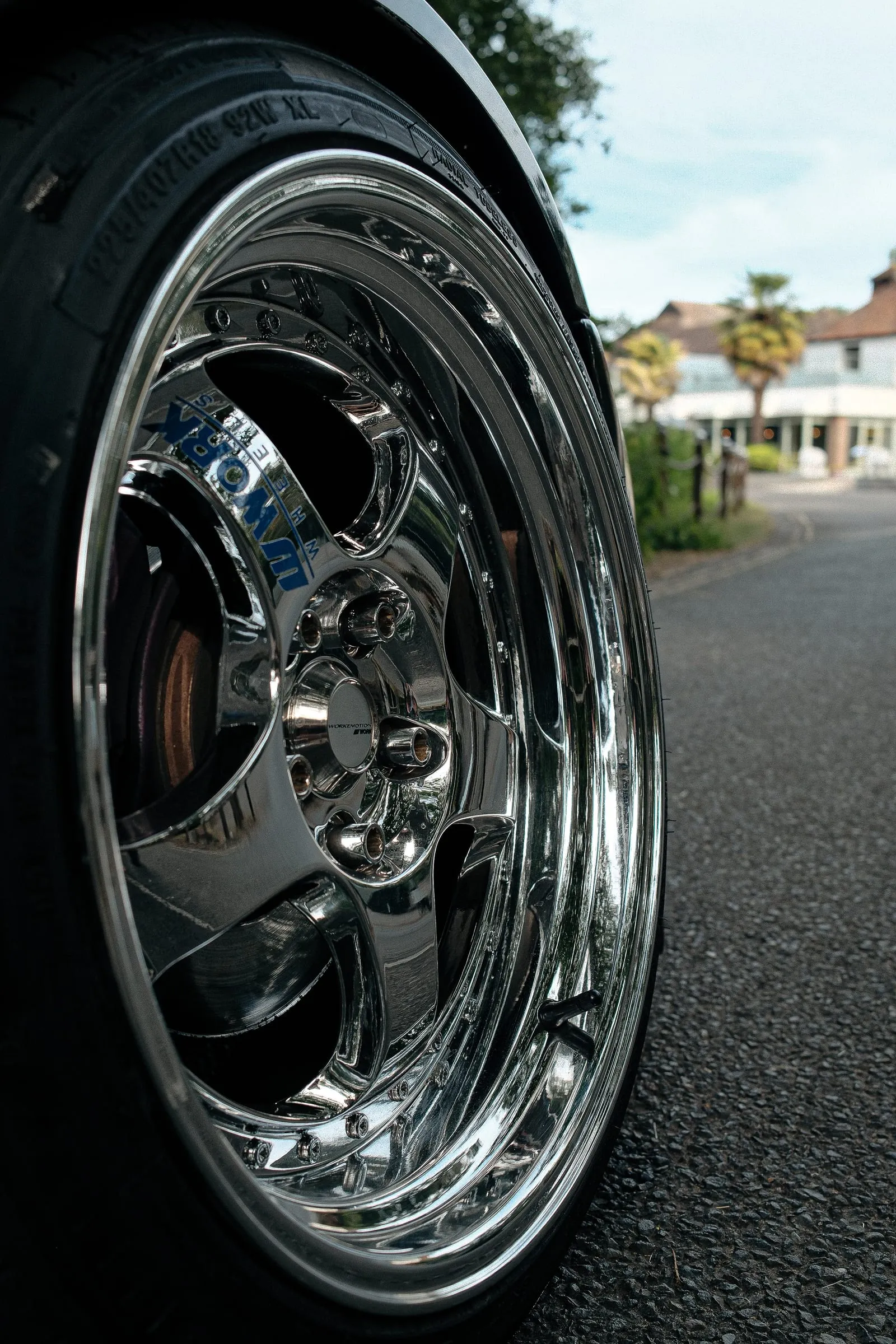 Close on a deep-dish chrome wheel.