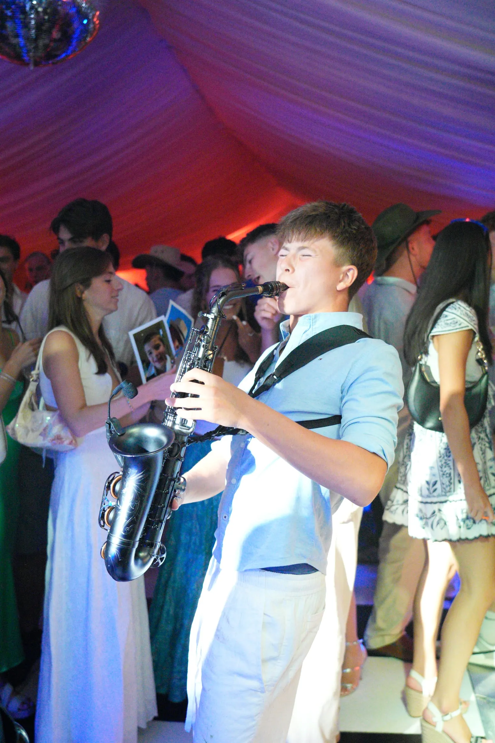 The saxophonist mid-note, the crowd around him.